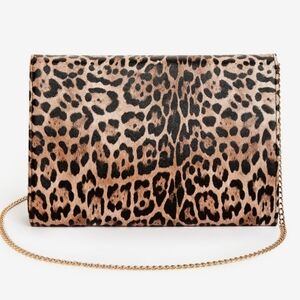 Leopard print shoulder bag with magnetic snap closure.